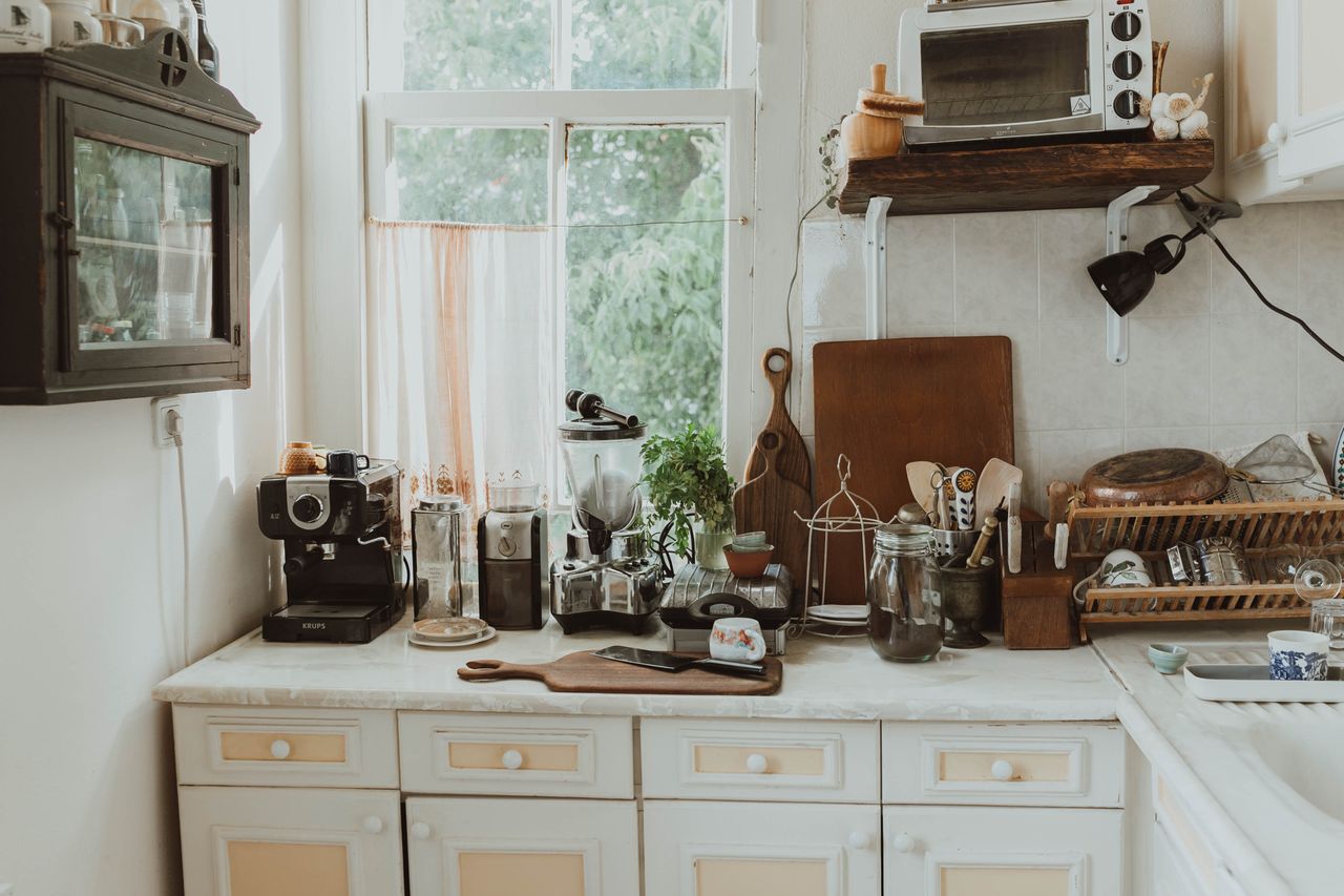 services-01 A charming kitchen space featuring vintage elements and natural lighting through a large window.